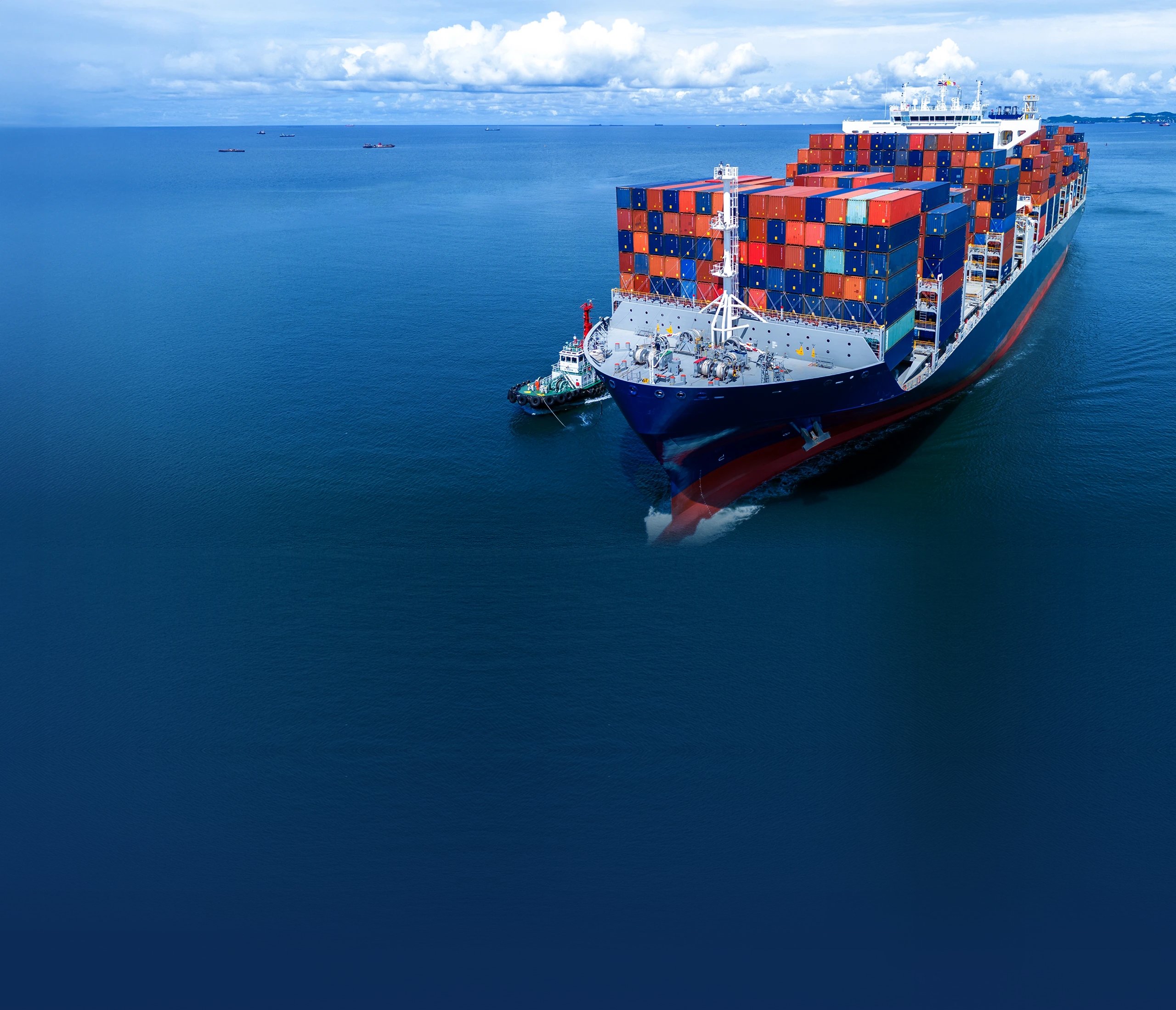 Container ship escorted by a tug at sea